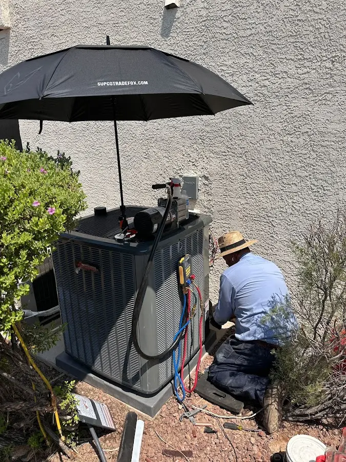 HVAC technician performing outdoor AC maintenance in Stillwater